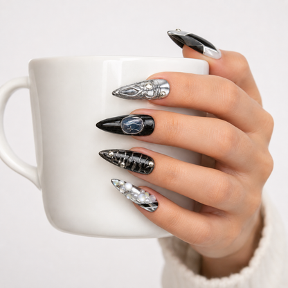 Black silver gothic press on nails worn on hand holding a white coffee cup