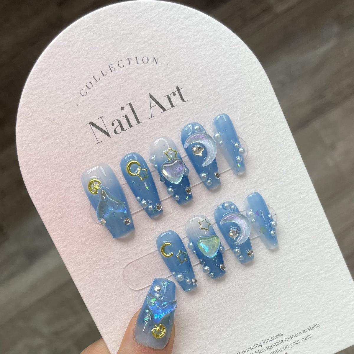 Blue celestial press on nail set with 3D charms and rhinestone details