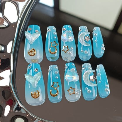 Blue celestial press on nail set with moon, star, heart and pearl decorations