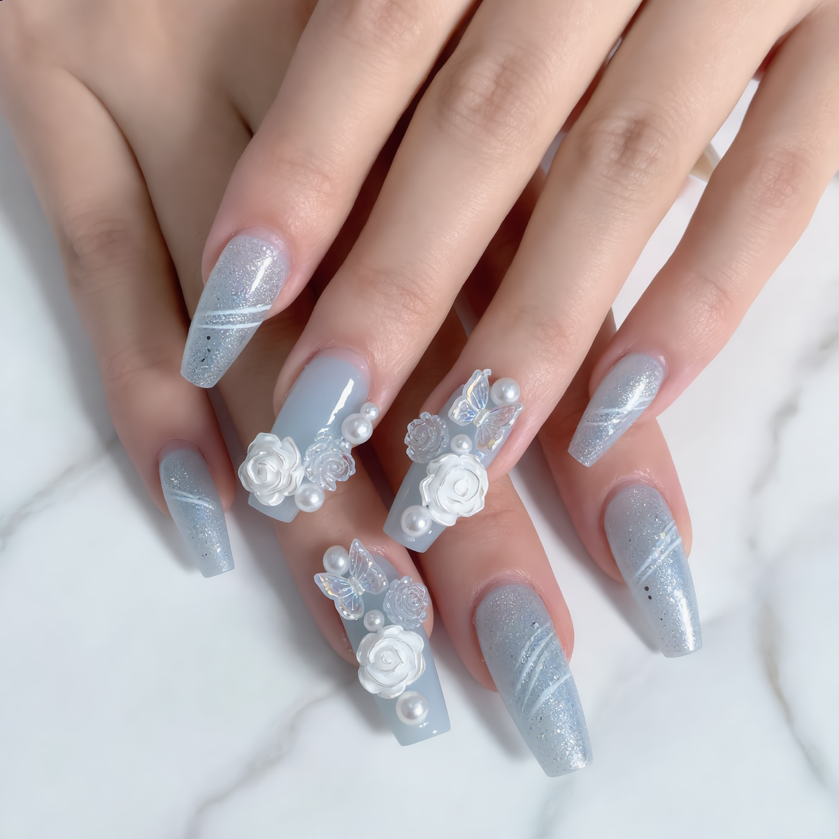 Blue floral press on nails with butterflies, pearls and 3D flower charms