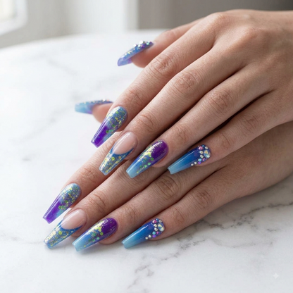 Blue purple coffin press on nails displayed on hands over white marble