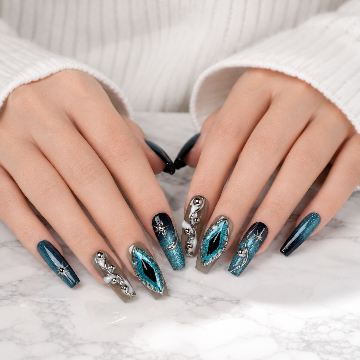 Blue teal cat eye chrome handmade press on nails displayed on both hands over a white marble table, reusable luxury fake nails.
