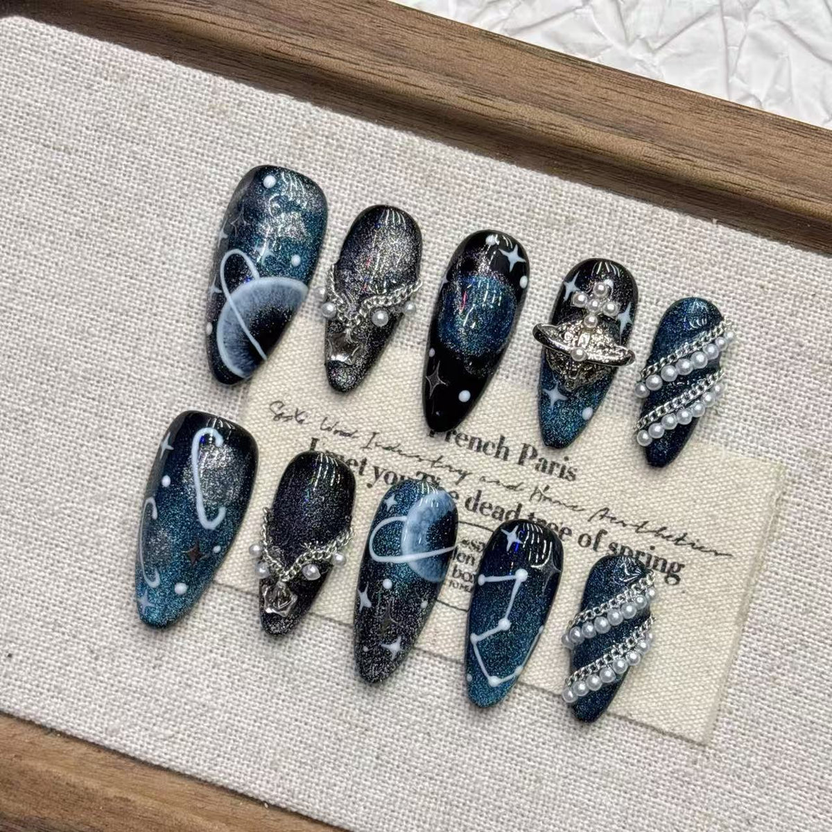 Celestial galaxy fake nails with blue shimmer, star details and 3D charms