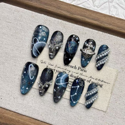 Celestial galaxy fake nails with blue shimmer, star details and 3D charms
