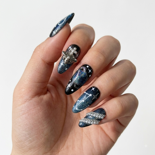 Celestial press on nails with dark blue galaxy art, stars and rhinestones
