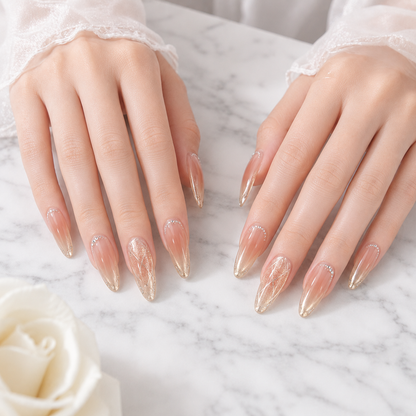 Champagne almond press on nails displayed on both hands over white marble