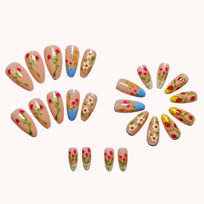 Floral press on nails set showing multiple nail sizes and designs