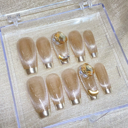 Full set of nude gold French press on nails with crystal and pearl details