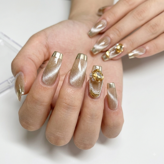 Gold French tip press on nails with nude shimmer and 3D crystal accents