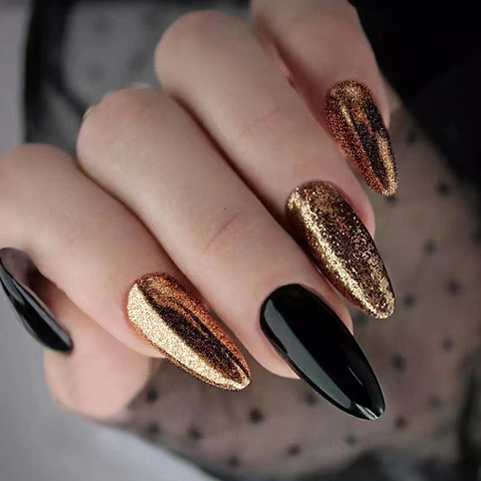 Luxury black and gold chrome press on nails with glossy mirror finish, handmade almond fake nails, reusable salon-quality nail set for elegant everyday wear.