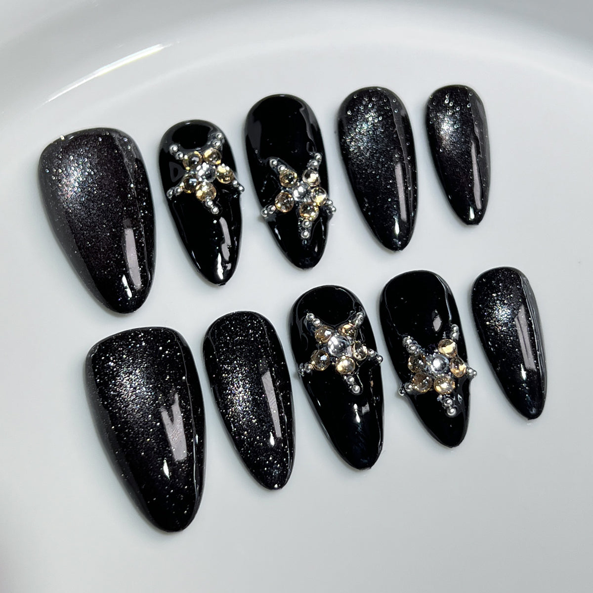 Luxury black crystal press on nails with glitter finish, handmade almond fake nails featuring sparkling rhinestone accents and reusable salon-quality design.
