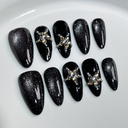 Luxury black crystal press on nails with glitter finish, handmade almond fake nails featuring sparkling rhinestone accents and reusable salon-quality design.