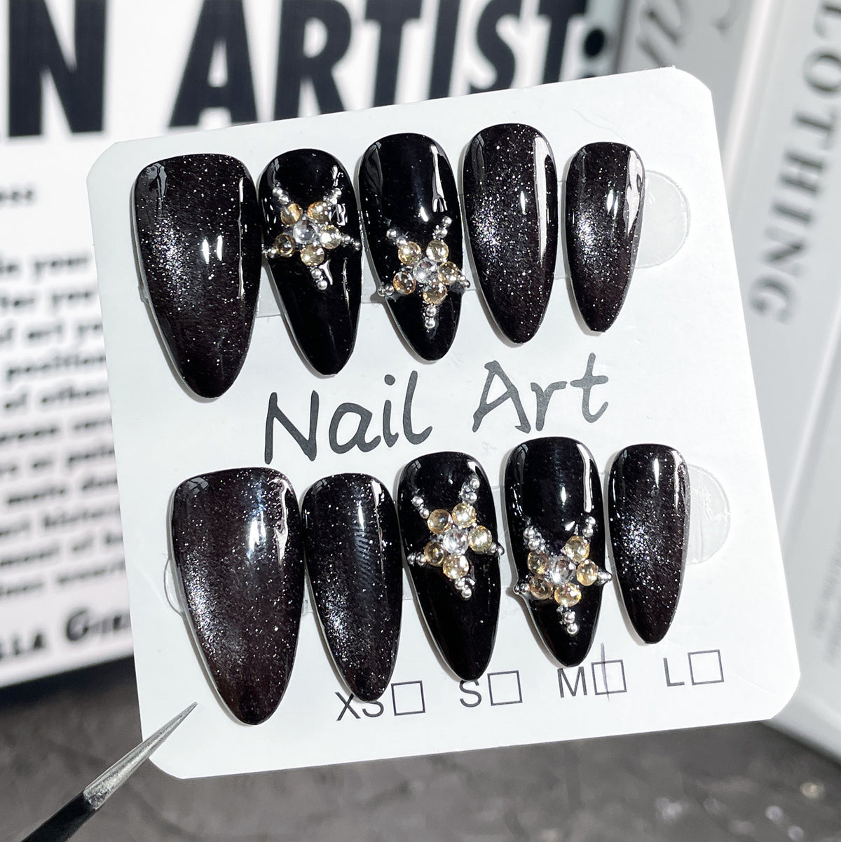 Luxury black crystal press on nails beautifully packaged, handmade reusable almond fake nails ready for gifting and special occasions.