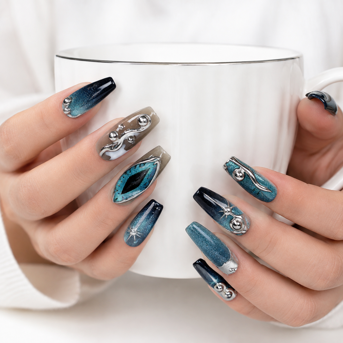Luxury blue teal cat eye chrome press on nails holding a white coffee cup, handmade reusable fake nails for women.