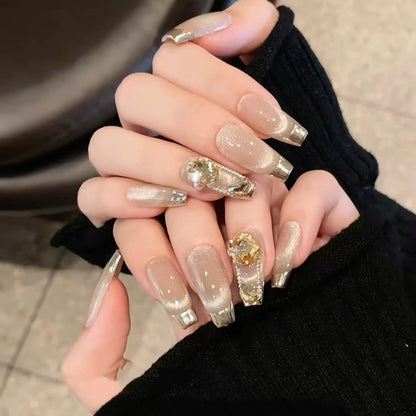 Luxury gold press on nails with nude shimmer, metallic tips and 3D gems