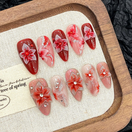 Luxury red floral 3D press on nails in almond shape with handcrafted flower details, glossy finish, reusable fake nails for weddings and special occasions.