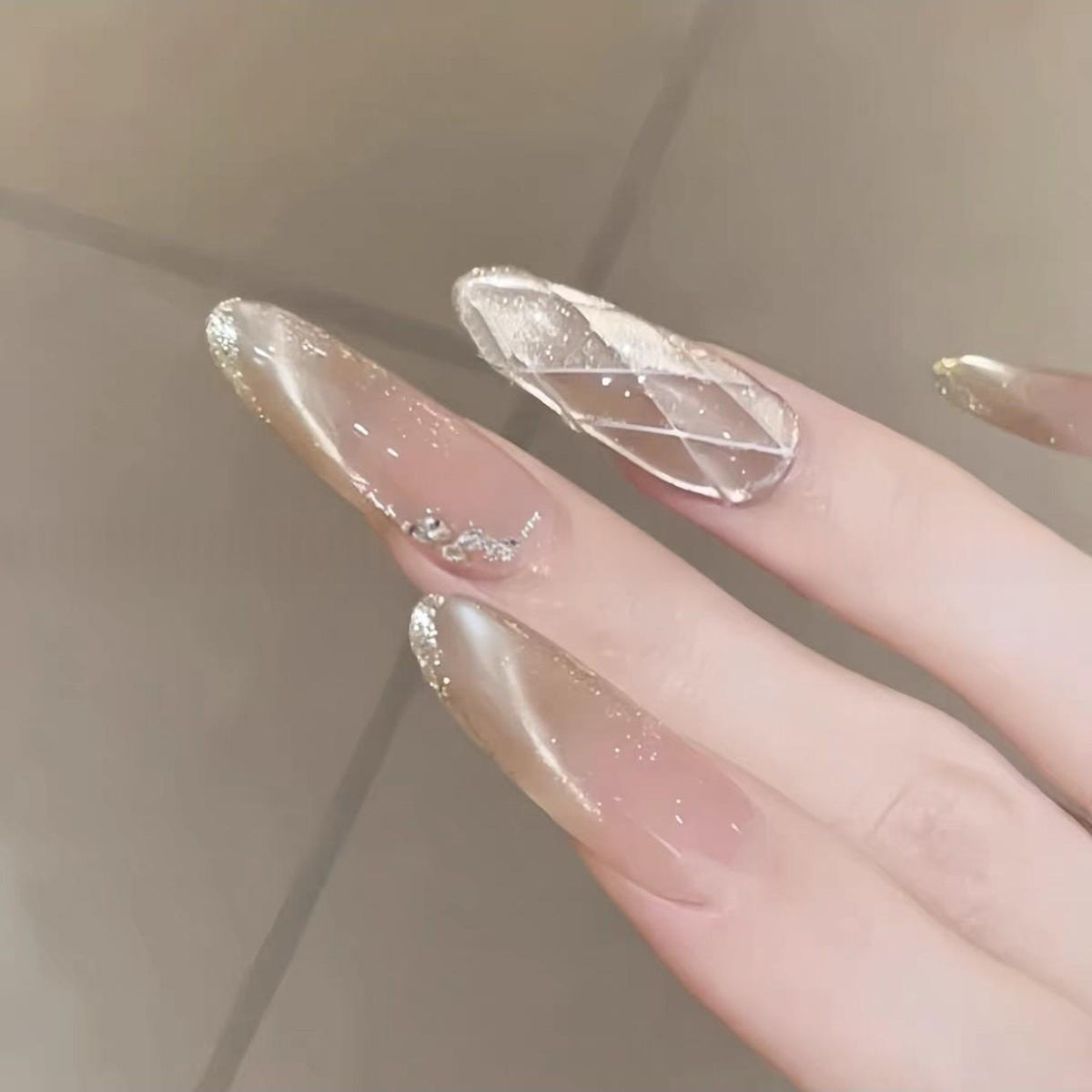Nude champagne glitter press on nails with delicate rhinestones and shimmering tips