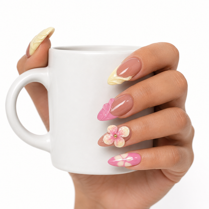 Pink 3D floral press on nails holding a white coffee cup