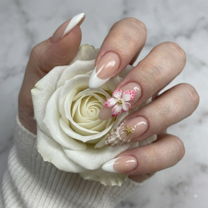 Pink 3D flower press on nails with crystal accents holding a white rose