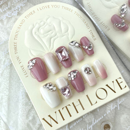 Pink French tip press on nails with white tips and rhinestone accents