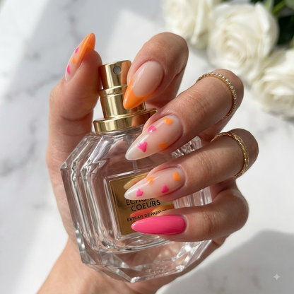 Pink and orange press on nails with heart nail art and long almond