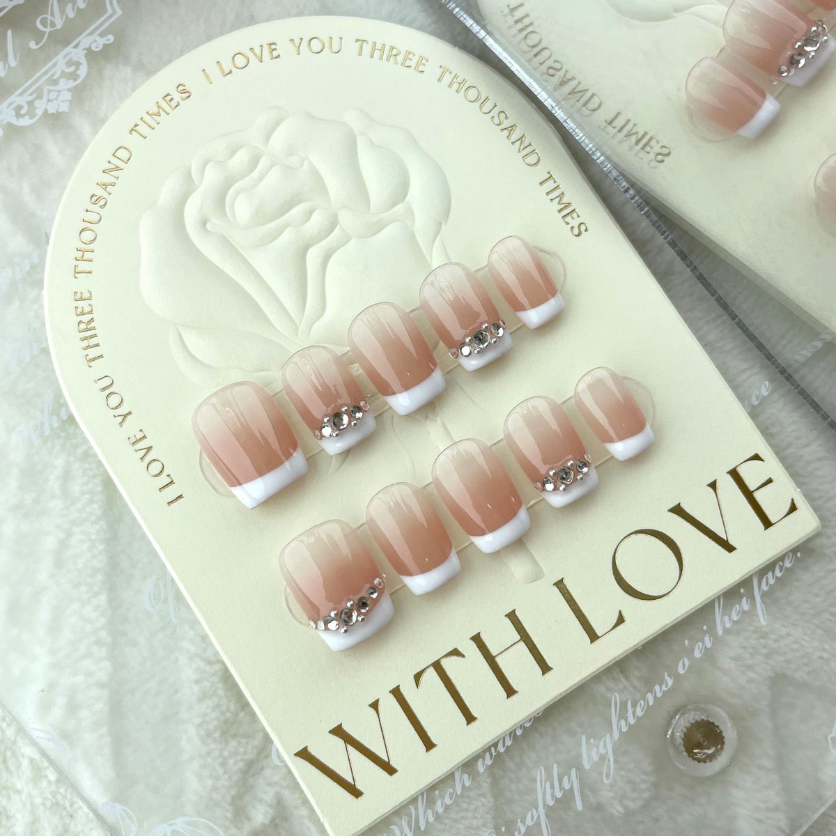 Pink and white press on nails with sparkling rhinestones and crystal charms