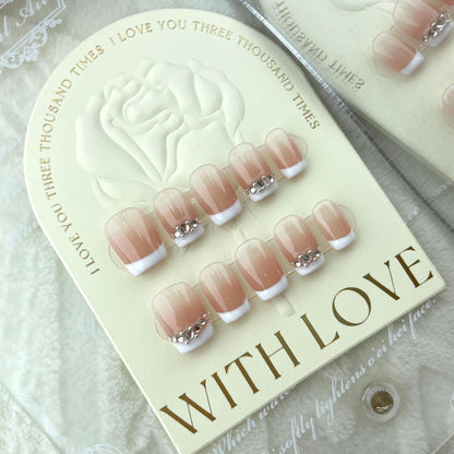 Pink and white press on nails with sparkling rhinestones and crystal charms