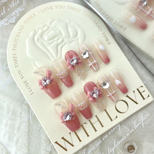 Pink bow press on nails with crystal heart charms and pearl details