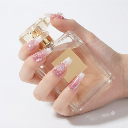 Pink glitter 3D floral press on nails holding perfume bottle
