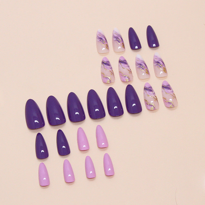 Purple marble press on nail set with gold accents and almond shape