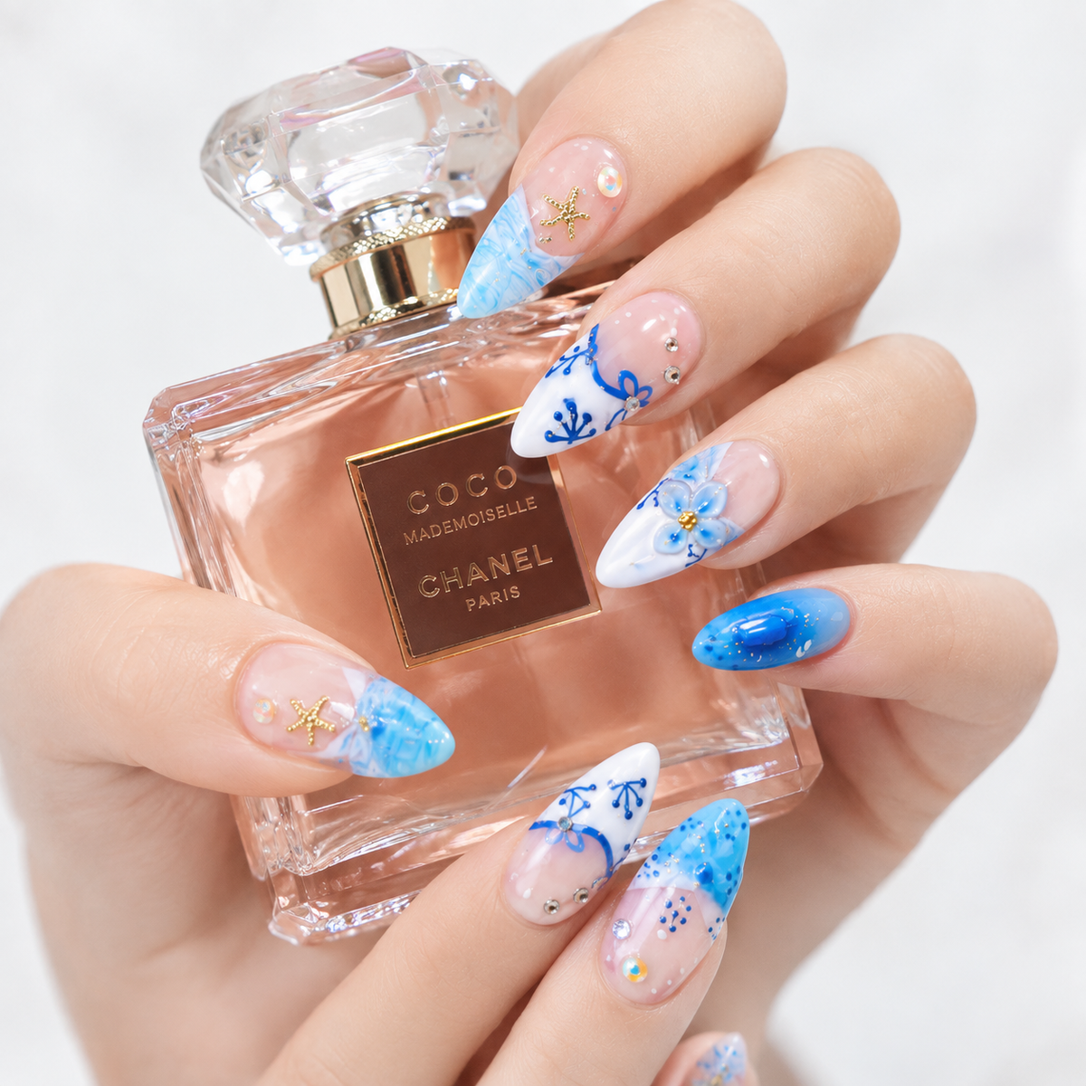 look.jpg
Luxury blue ocean press on nails with floral art, rhinestones and gold starfish charms
