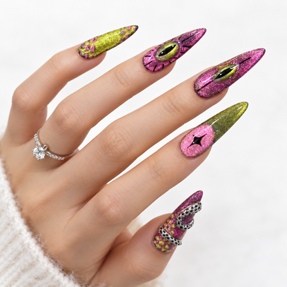 Pink and green stiletto press-on nails with glitter, eye designs and 3D silver details