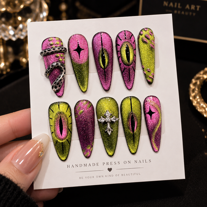 Pink and green stiletto press-on nail set with glitter eye designs and 3D nail art
