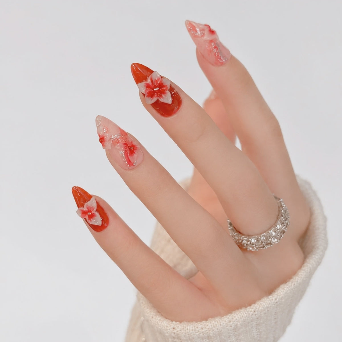 Elegant red floral almond press on nails with handmade 3D flowers, glossy finish and salon-quality reusable fake nails for women.