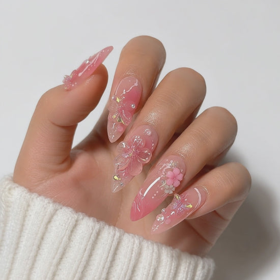 Pink floral 3D almond press on nails with handcrafted flower details, glossy finish, luxury reusable fake nails for elegant everyday wear.