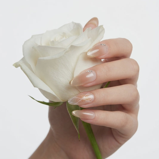 Nude champagne glitter press on nails with delicate rhinestones and shimmering tips