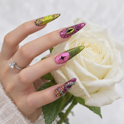 Luxury pink and green stiletto press-on nails with glitter eye designs and 3D embellishments