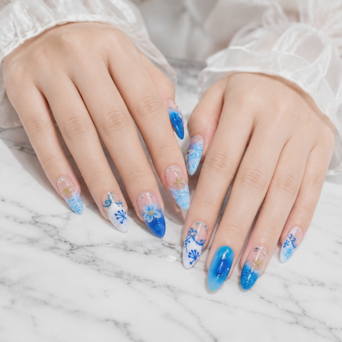 Blue 3D floral press on nails with ocean wave nail art and rhinestone accents