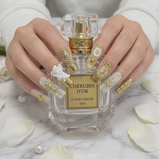 Luxury gold angel press on nails with crystal charms holding a perfume bottle