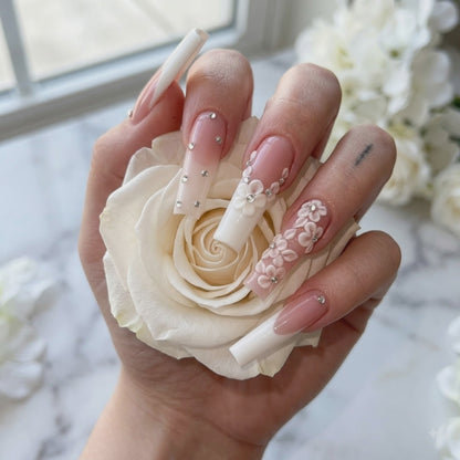 Luxury pink floral press on nails with 3D flowers holding a white rose