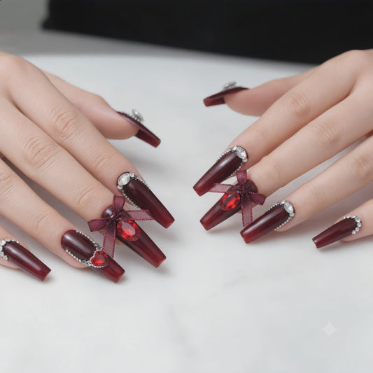 Long burgundy press on nails with crystal rhinestones displayed on both hands